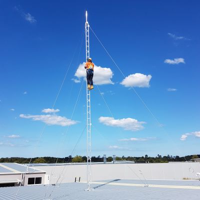Technician climbing an aluminium roof tower